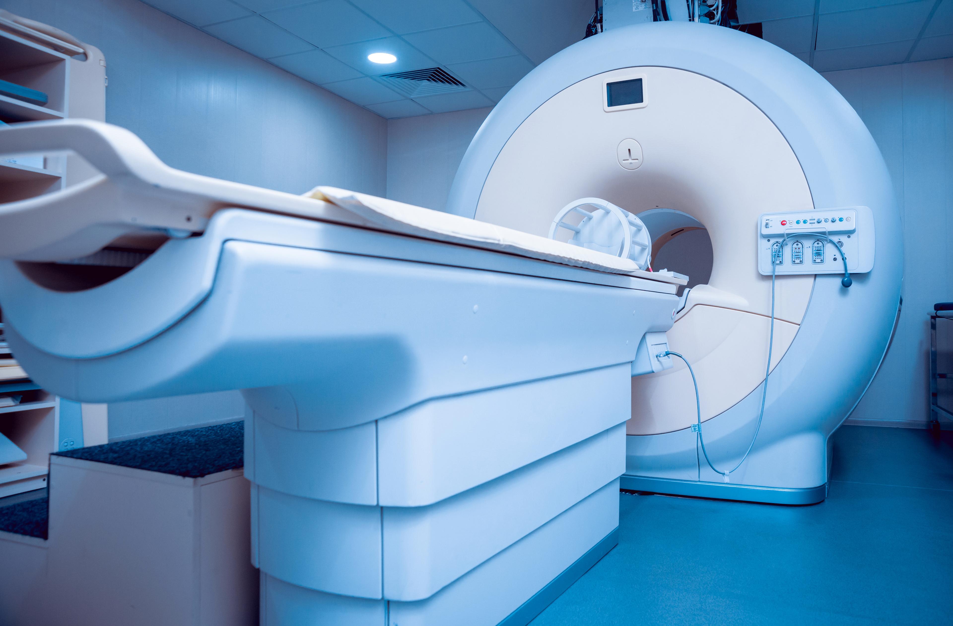 MRI Service: MRI scanner close view with patient table and controls